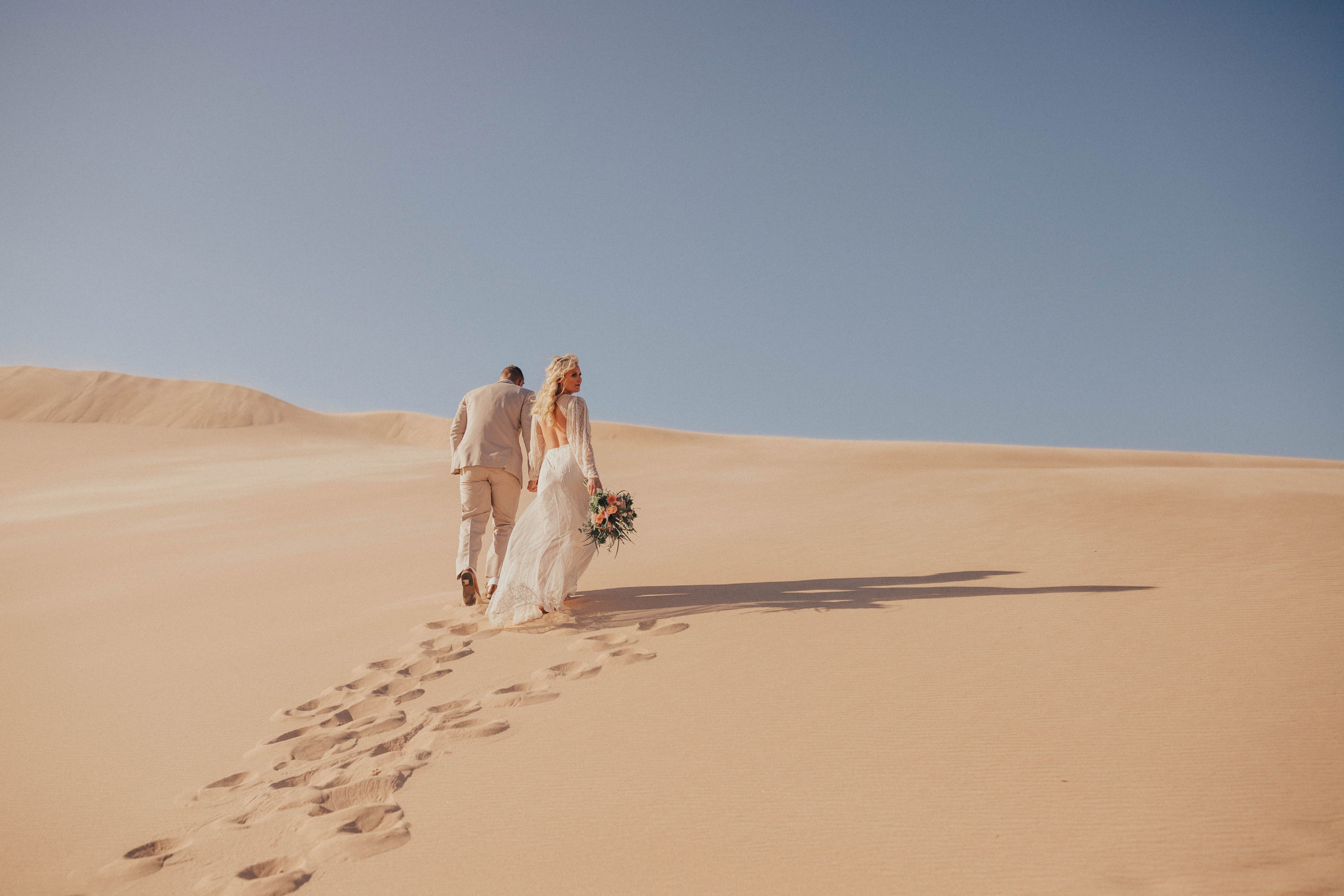 Ian and Annabelle Sleeman walking up Silver Lake Sand Dunes